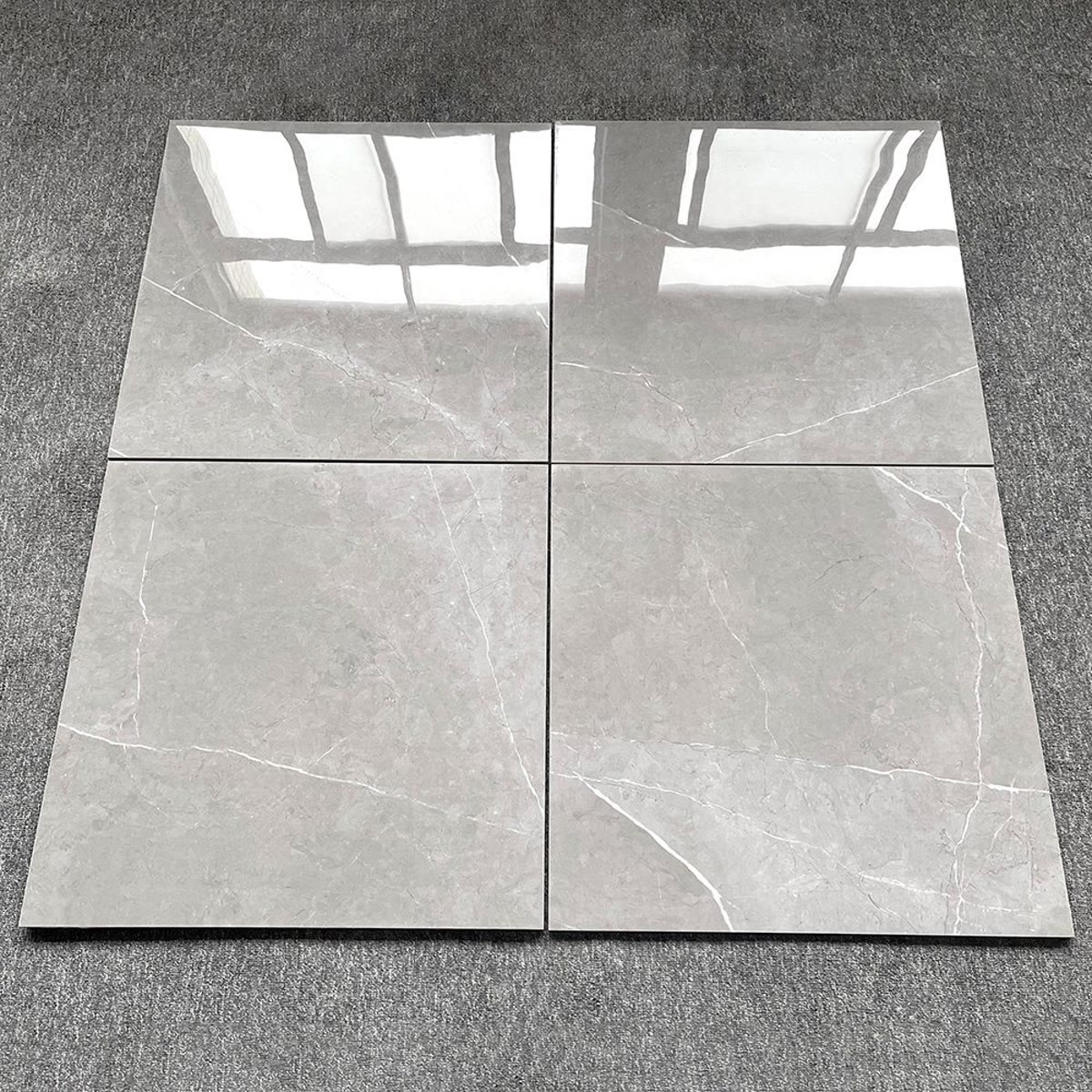 Four polished porcelain tiles with a stone finish.